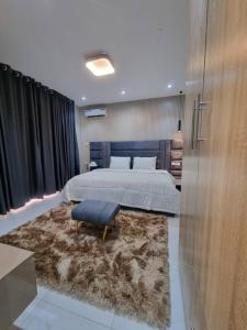 a bedroom with a large bed and a large rug at 1 Bedroom Apt Sabolak Suite Haven in Ikate