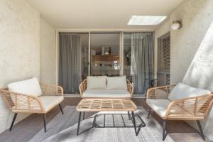 a living room with two chairs and a table at Walk to Old Town - 1BR Condo, Heated Pool and Patio in Scottsdale