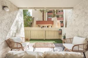 a patio with chairs and a couch and a table at Walk to Old Town - 1BR Condo, Heated Pool and Patio in Scottsdale