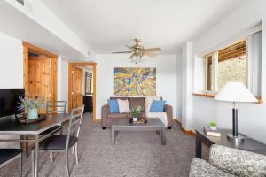 a living room with a couch and a table at St Marys Glacier Getaway in Ninetyfour +24 photos