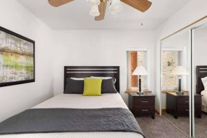 a bedroom with a bed and a ceiling fan at St Marys Glacier Getaway in Ninetyfour