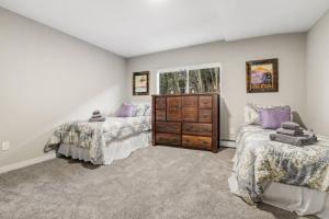 a bedroom with two beds and a dresser at Cabin by North Clear Creek. Private Hot Tub. Pets in Central City