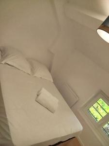 En eller flere senge i et værelse på Petit nid Dacquois