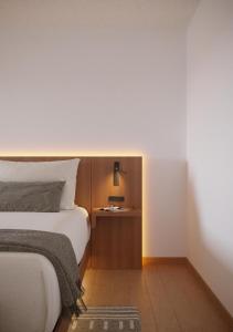 a hotel room with a bed and a night stand at The Amaya - 21 and older only in Fort Wayne