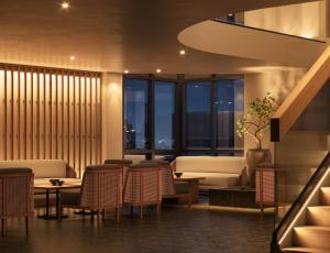 a restaurant with tables and chairs and windows at The Amaya - 21 and older only in Fort Wayne