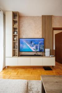 a living room with a large flat screen tv at M&M apartment in Pirot