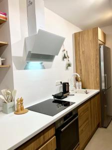 a kitchen with a sink and a stove top oven at Koselig Lodge in Pídhasos +19 photos