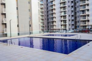 a swimming pool in front of some tall buildings at New modern apartment in Barranquilla