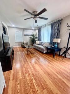 a living room with a couch and a ceiling fan at Family Comfort with Graceful Stays in Decatur