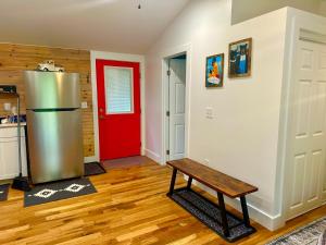 a kitchen with a refrigerator and a red door at Beary Cozy in Fairview +13 photos