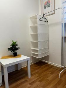 a white table with a potted plant on it at Frankenthal in Bobenheim-Roxheim