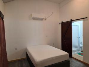 a small bedroom with a bed and a window at My Beach House in Tela