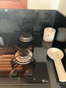 a stove top with a candle on a kitchen counter at Chalé I - Village da Serra in Serra de São Bento +62 photos