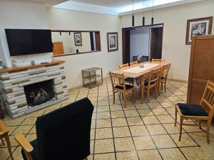 a dining room with a table and a fireplace at MIRAMAR departamento casa in Miramar