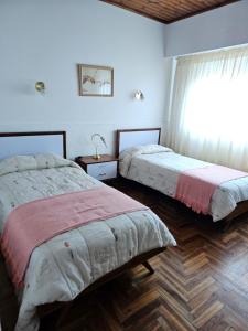 En eller flere senge i et værelse på MIRAMAR departamento casa