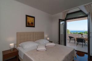 a bedroom with a bed with a view of a patio at Luxury Rooms Near the Beach2 in Split