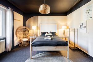 a bedroom with a bed in a room at Japan Universe Spa & Arcade in Mulhouse