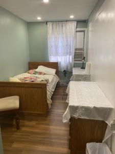 a room with two beds and a window at Peaceful and Private Small Room in Brampton