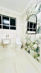 a bathroom with a toilet and a sink at Illi Boutique Guest House in Durban +10 photos