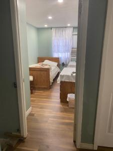 a hallway with two beds in a room with a window at Peaceful and Private Small Room in Brampton