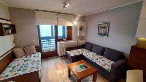 a small living room with a couch and a table at Apartman Bjanka 308 in Kopaonik