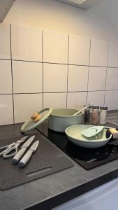 a kitchen counter with plates and utensils on it at Alsace in Beauvais
