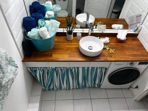 a bathroom with a sink and a washing machine at Sunset View & Ocean Breeze in Cul de Sac