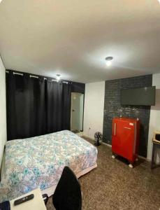a bedroom with a bed and a tv in it at Faça tudo a pé in Limeira