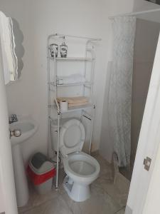 a small bathroom with a toilet and a sink at apartamento privado trujillo huanchaco in Huanchaco
