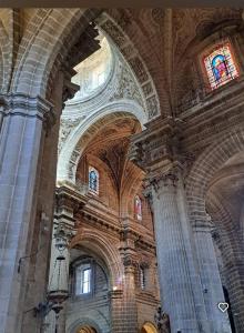 a large church with a vaulted ceiling and windows at TU ESCONDITE in Jerez de la Frontera