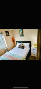 a bedroom with a bed and a vase of flowers at Parnell pavilion-Elegant escape at Central Auckland in Auckland