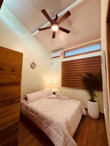 a bedroom with a bed with a ceiling fan at Villas MAMALU in Cocles +12 photos