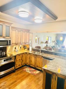 a kitchen with wooden cabinets and a counter top at Ocean Serenity in Pensacola