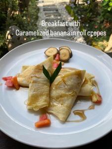 a white plate of food on a table at Ningmas Escape by Sidhi Hospitality Experiences in Ubud
