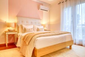 a bedroom with a large bed and a window at Alzira's Place, a Home in Madeira in Quinta do Almeida