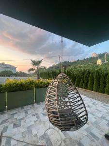 a large rattan swing hanging from a roof at Sea and Natural Adalet Suits in Çağlayan