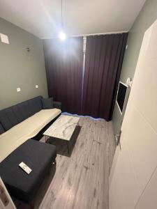 a small room with a bed and a couch at Sea and Natural Adalet Suits in Çağlayan