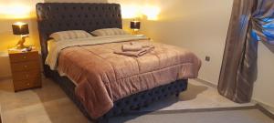 a bedroom with a large bed with a large headboard at Indepented Residence Serres in Levkón