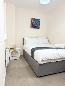 a bedroom with two beds and a side table at Modern 3-Bedroom Wolverhampton City Home, WiFi&Parking in Wolverhampton