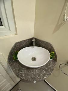 a bathroom with a white sink in a room at Residence el michouar in Laayoune +16 photos