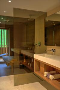a bathroom with a sink and a large mirror at Aparthotel Iris - inklusive Wildschönau Premium Card in Auffach