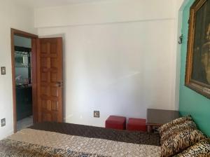 a bedroom with a bed and a table and a door at Casa de Francisco in Belém