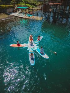 a group of people on surfboards in the water at Equinoccio Hotel in Santa Ana