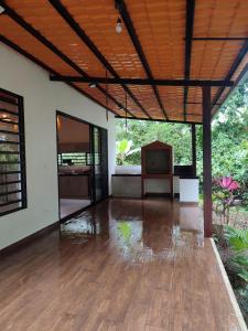 an empty room with a wooden floor and a television at Casa de Campo Riverside in Puerto Quito +24 photos