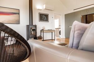 a living room with a couch and a table at Diamond Skies in Bicheno