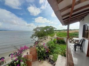 a balcony of a house with a view of the water at Cabaña Barbacoas in Santa Ana