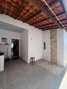 an empty room with a wooden ceiling and a table at Casa Jardins in Barreirinhas