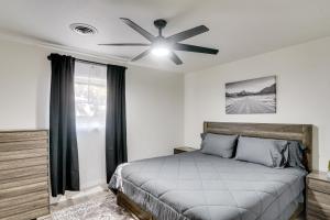 a bedroom with a bed and a ceiling fan at Backyard and Game Room! Home in Heart of Midland in Midland Airpark
