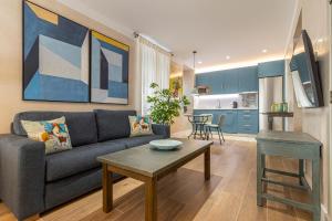 a living room with a couch and a table at La Casa de la Plaza del Arroyo - Traditional Luxury in Jerez in Jerez de la Frontera