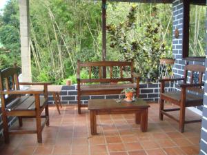 a porch with chairs and a bench and a table at mountain house Mangalobby in Copacabana +156 photos